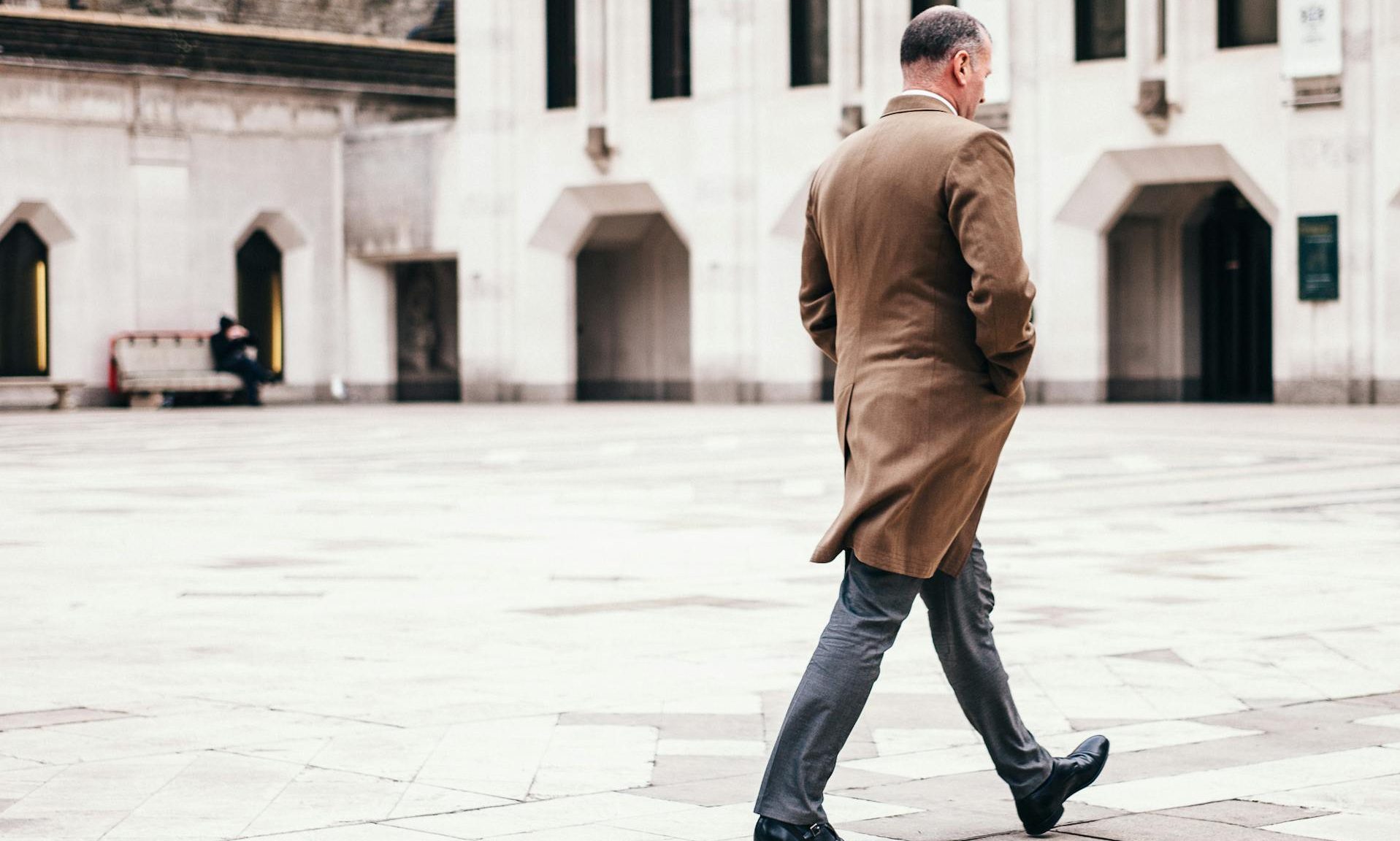 man walking long coat