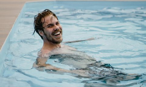 man swimming in pool