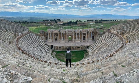 man standing in Roman ampitheater