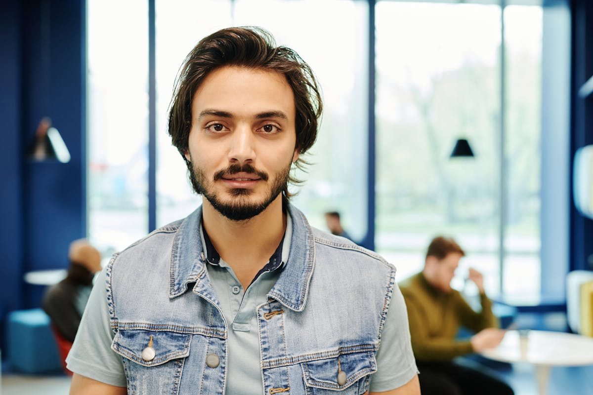 man in jean vest with longer hair