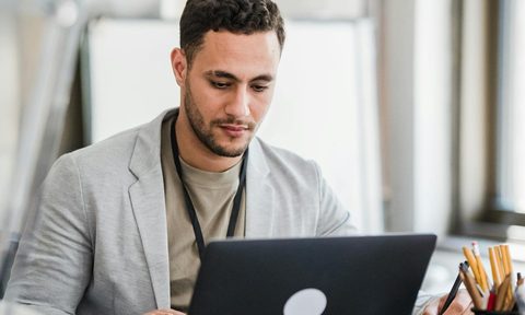 man working on computer desk