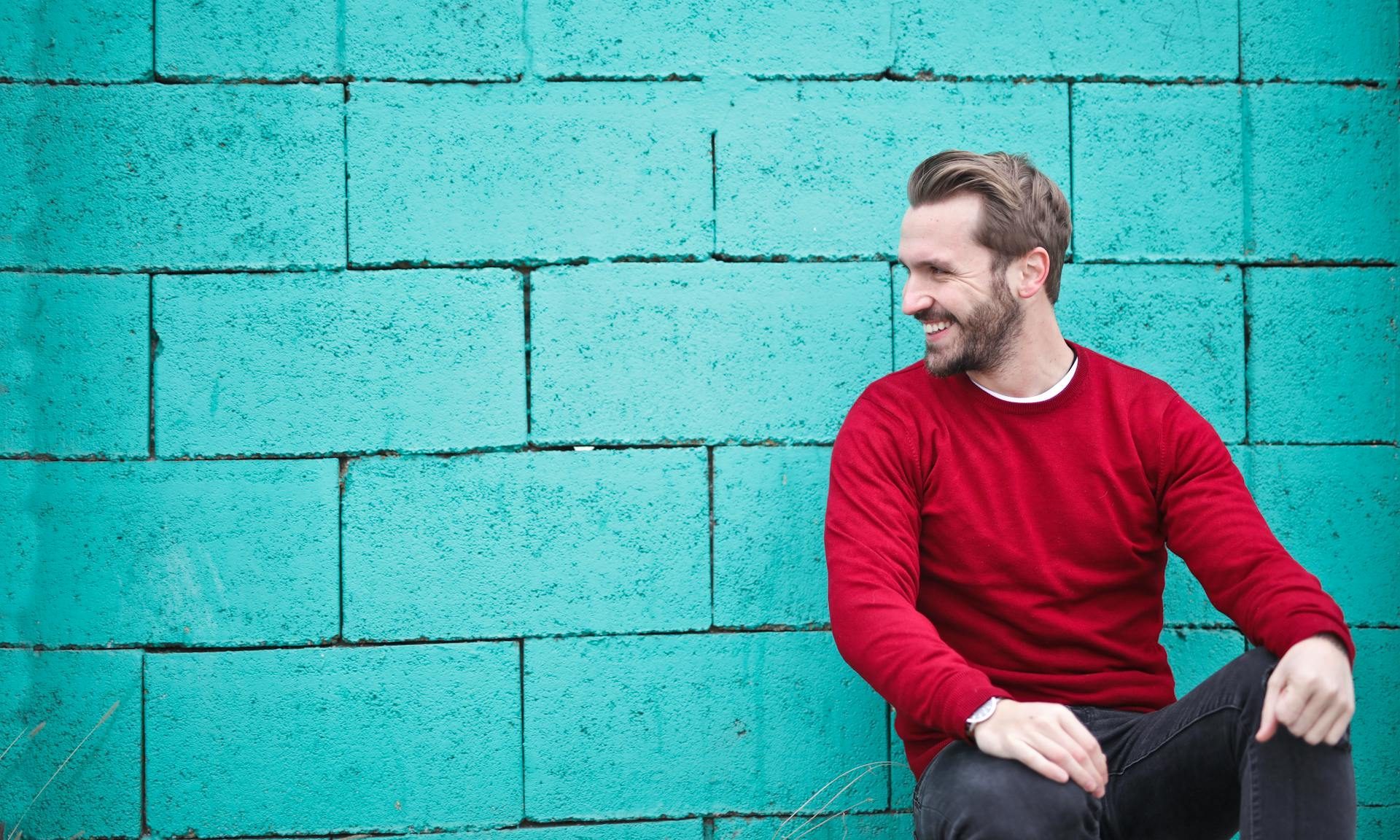 happy man smiling sitting down