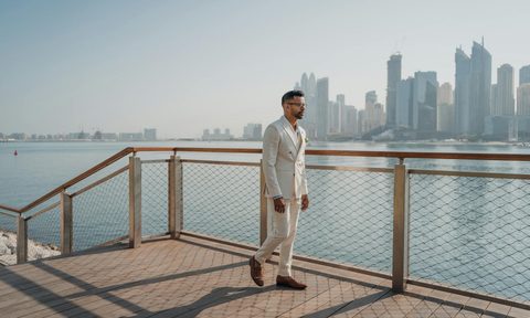man walking by water