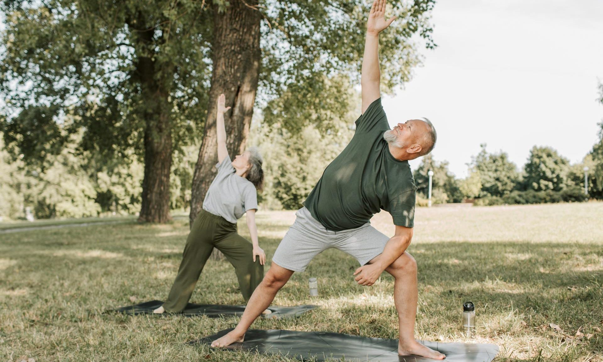 man and woman doing yoga outside