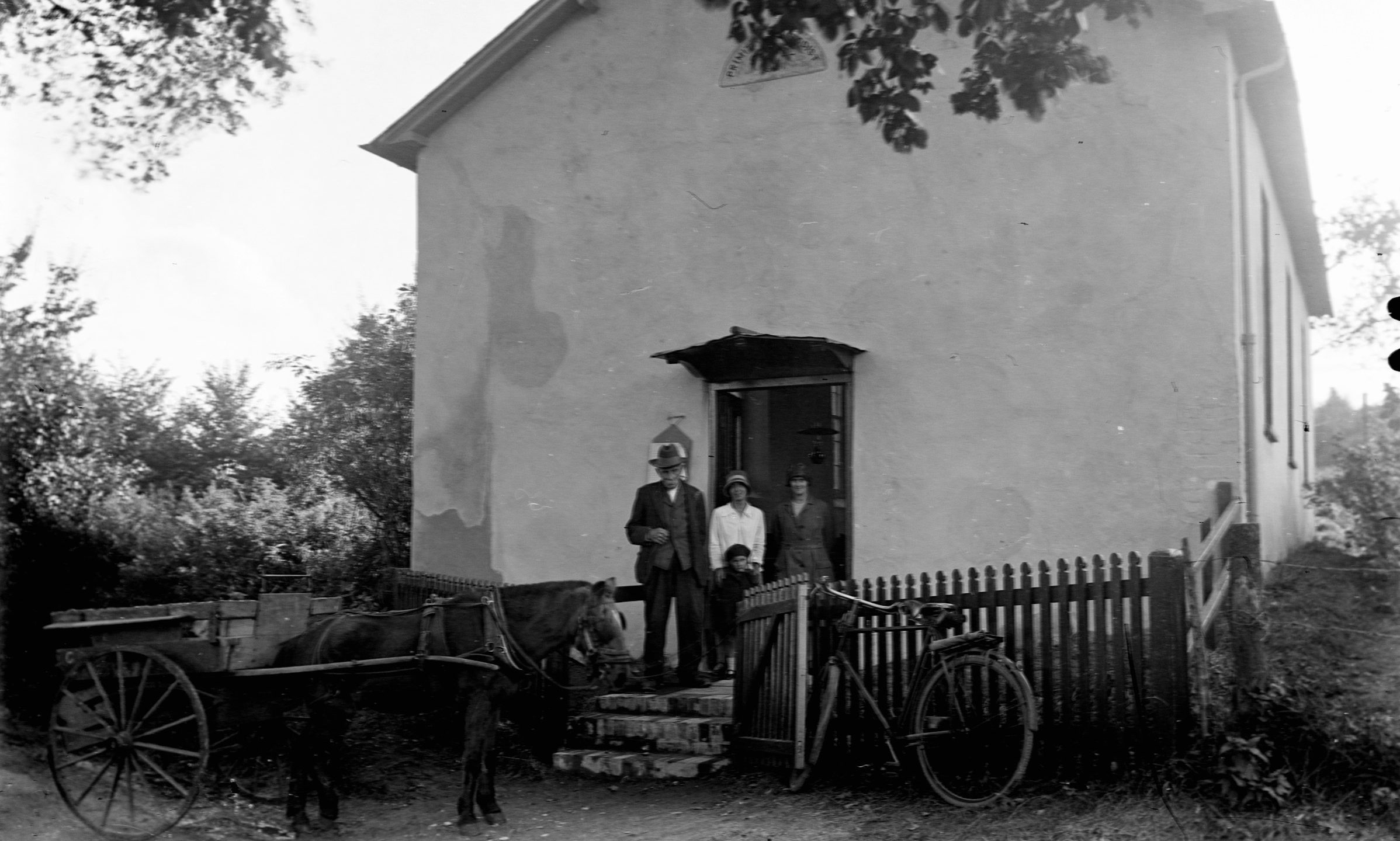 historical picture of family by house