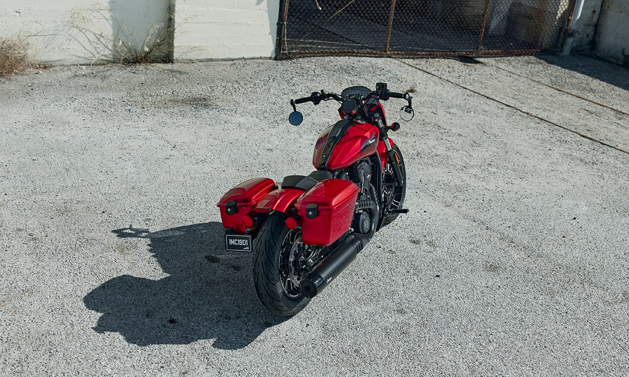 2026 Indian Sport Scout RT right rear three-quarter view parked on concrete near an industrial building.