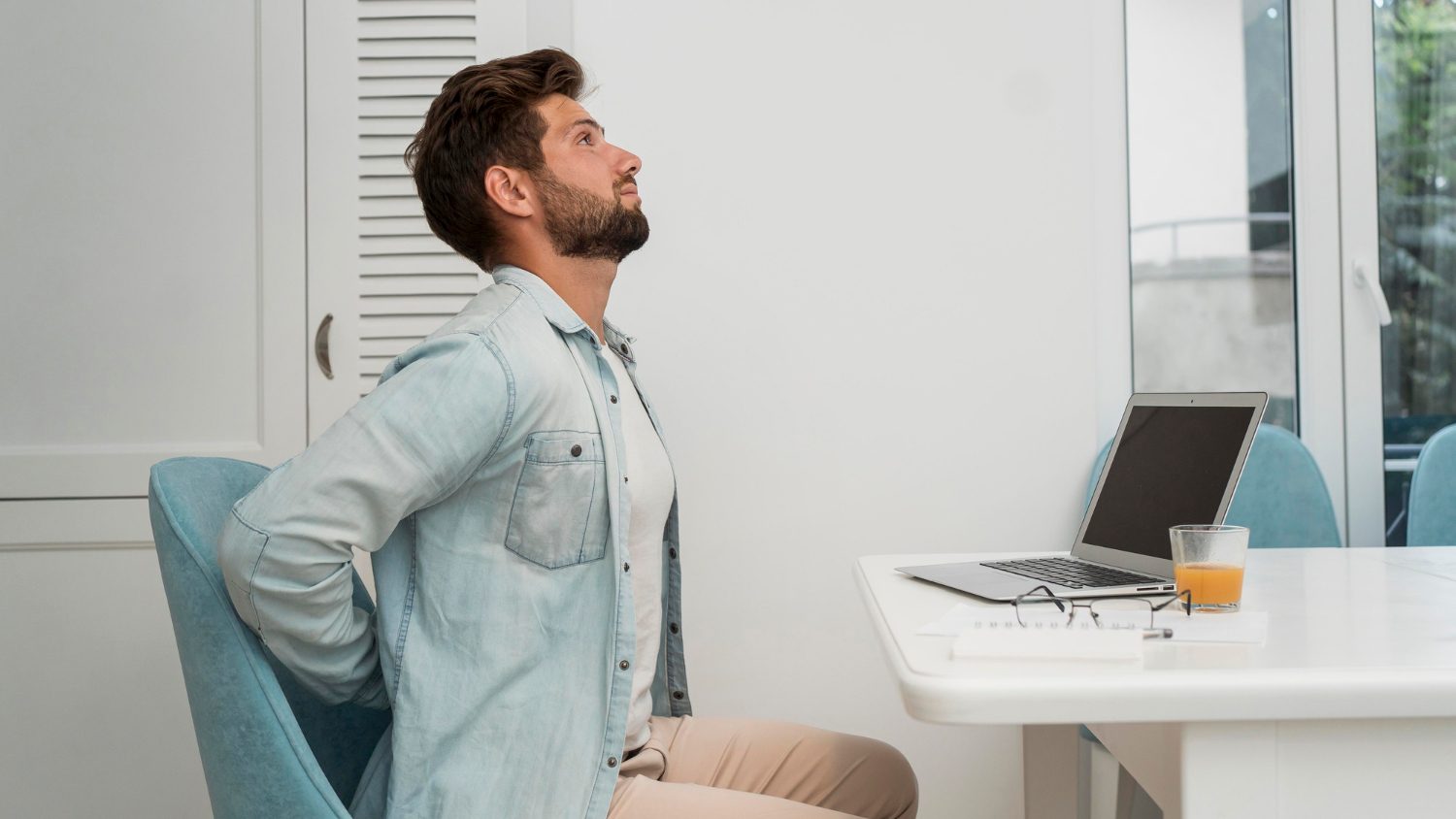 Man working at desk with bad posture.