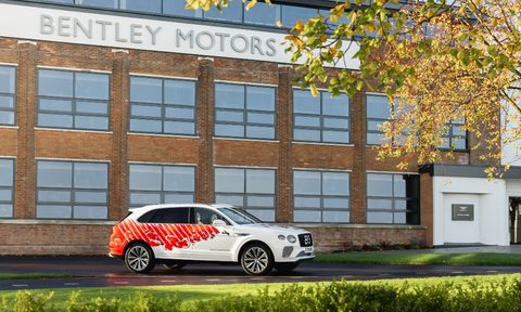 Bentley 2025 Bentayga Remembrance Car parked in front of a Bentley Motors factory building in Crewe.