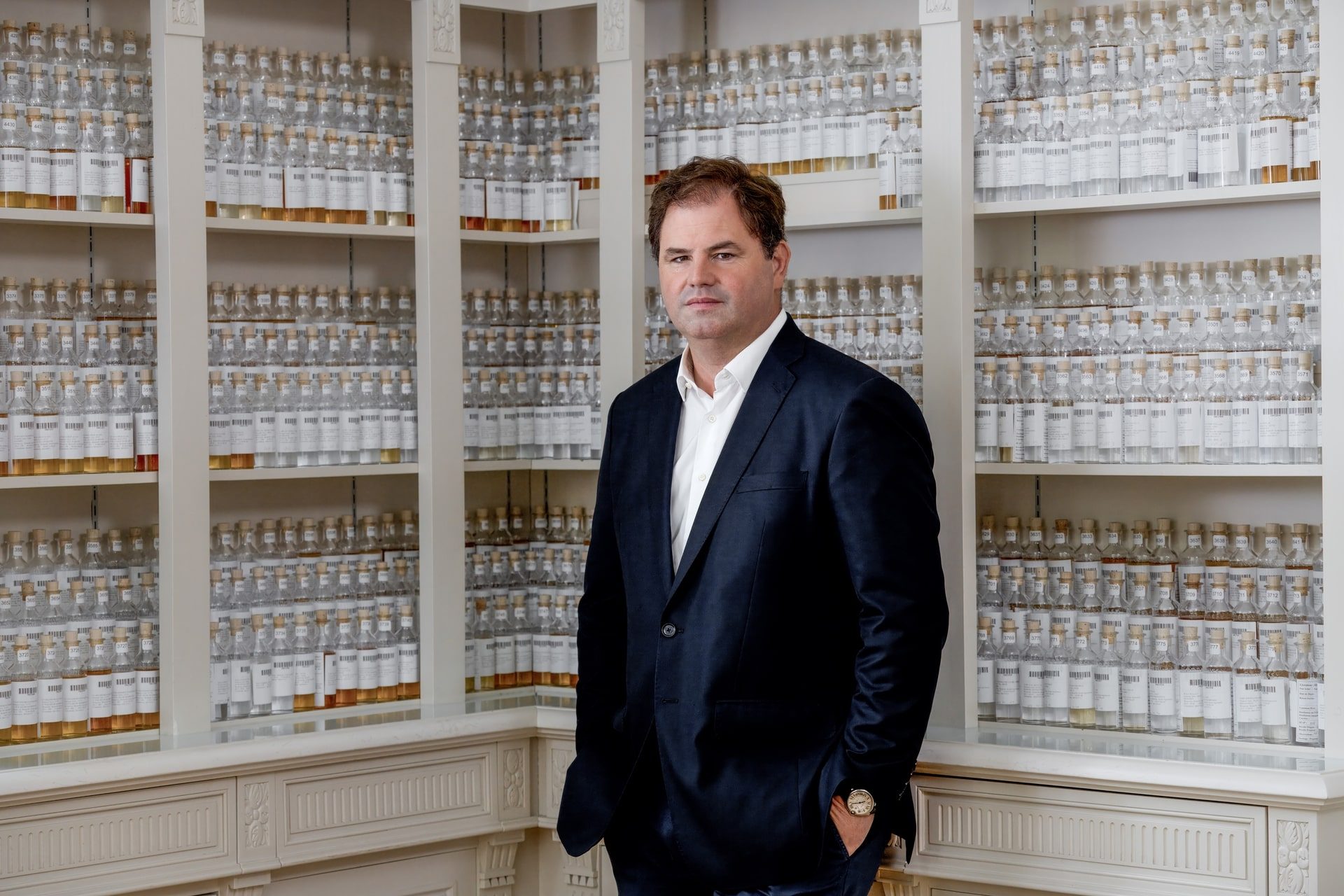 Renaud Fillioux de Gironde standing in front of a wall of spirit samples