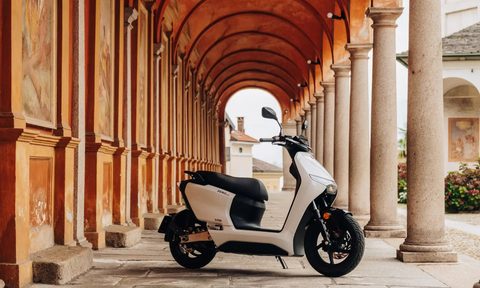 Zero Motorcycle LS1 Scooter parked under a series of building arches.
