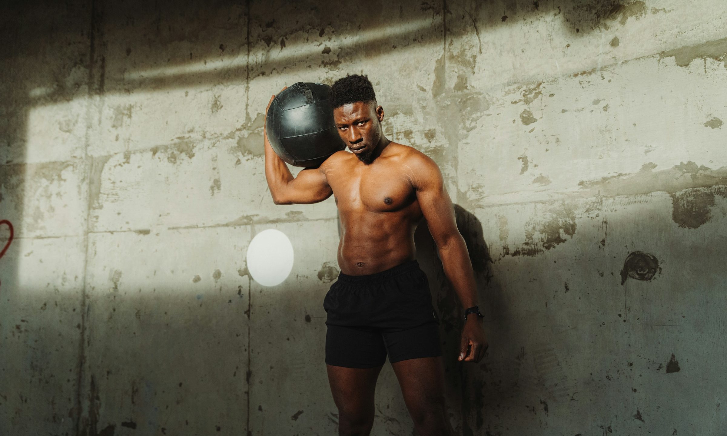 man athletic holding medicine ball