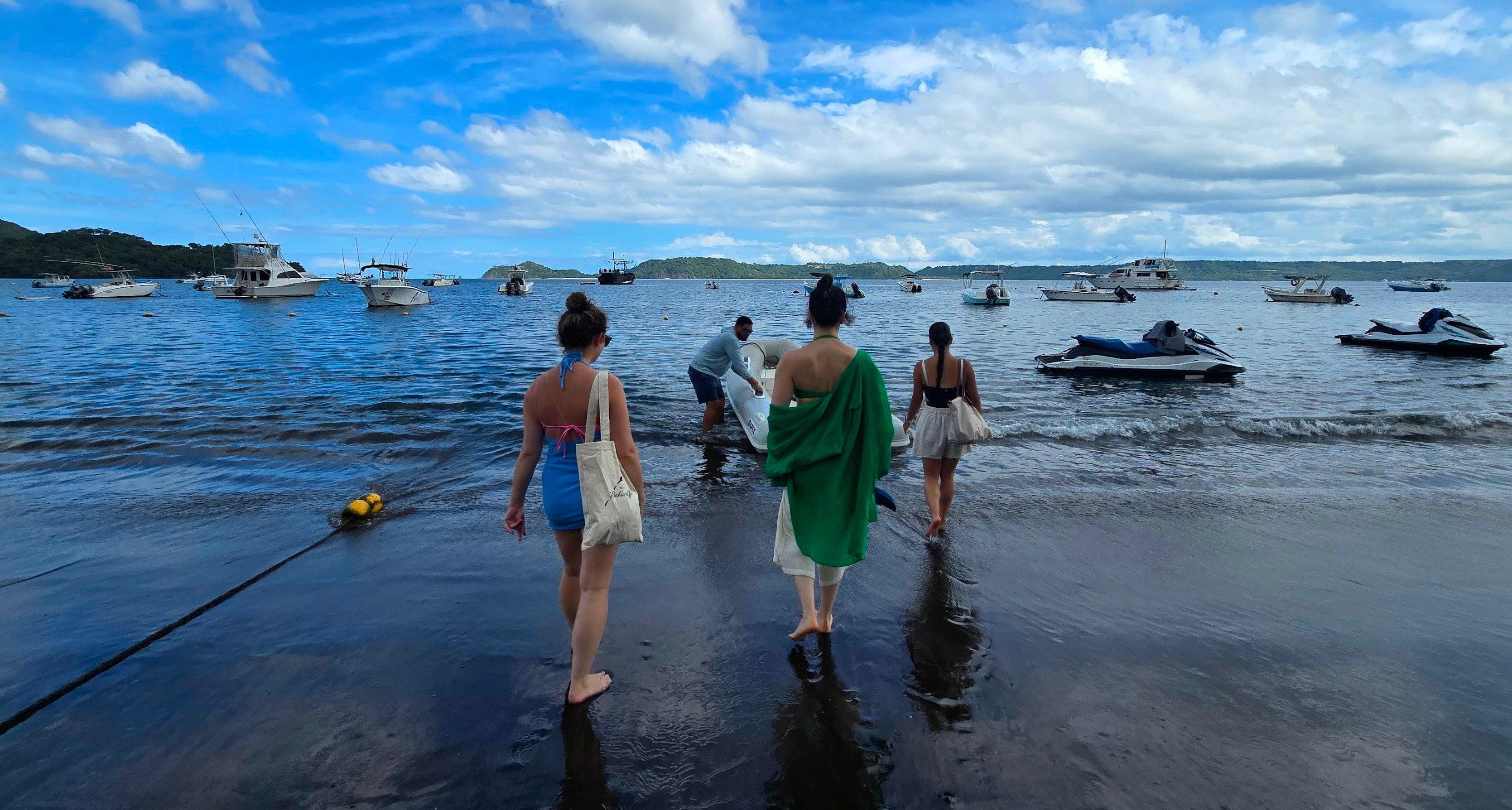 people walking on a beach in costa rica