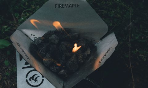 Fire Maple Antarcti Fire Pit burning in a dark outdoor scene.