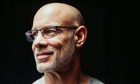 side view of man with bald head and glasses
