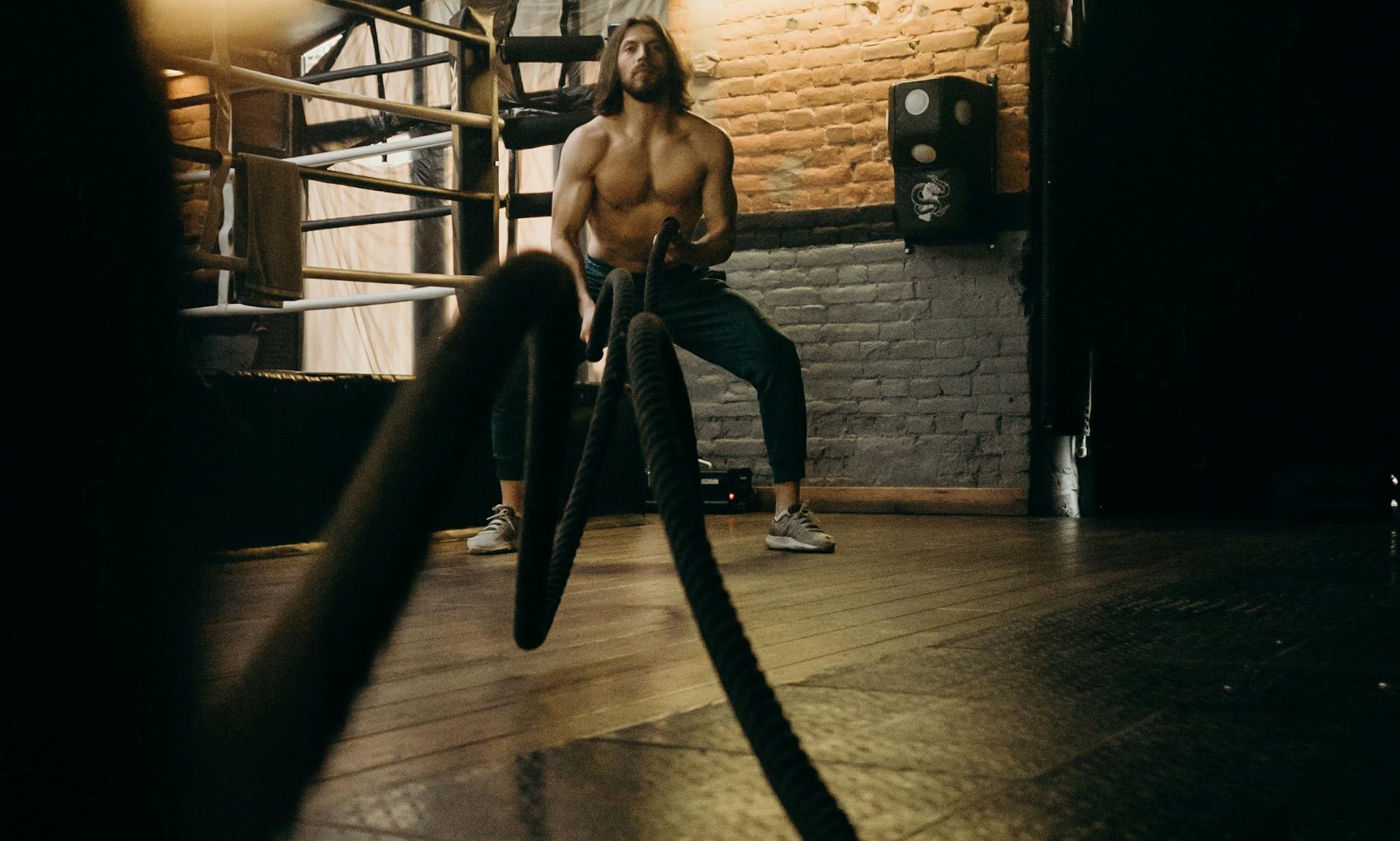 man exercising working out rope HIIT gym