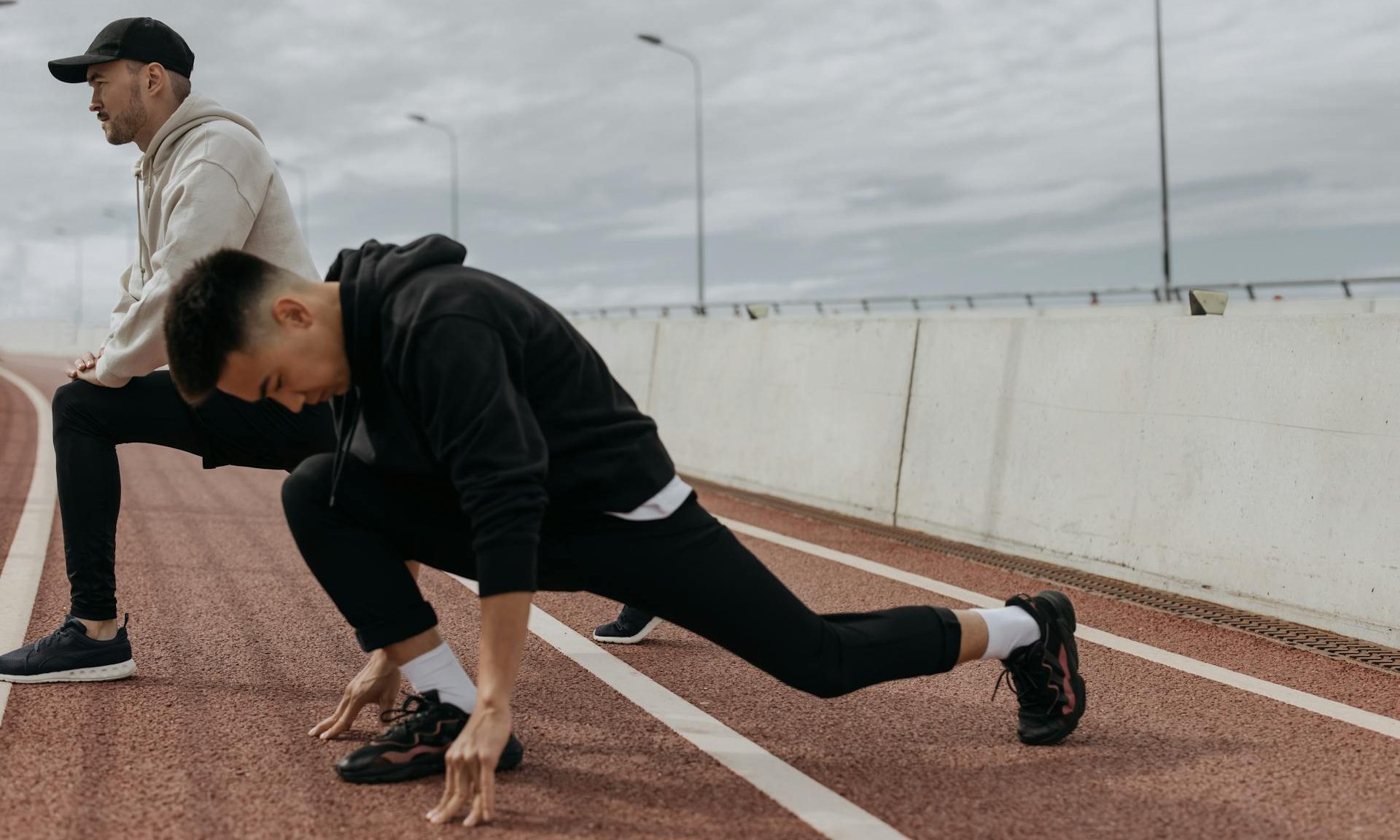 men exercising doing lunges stretches outside