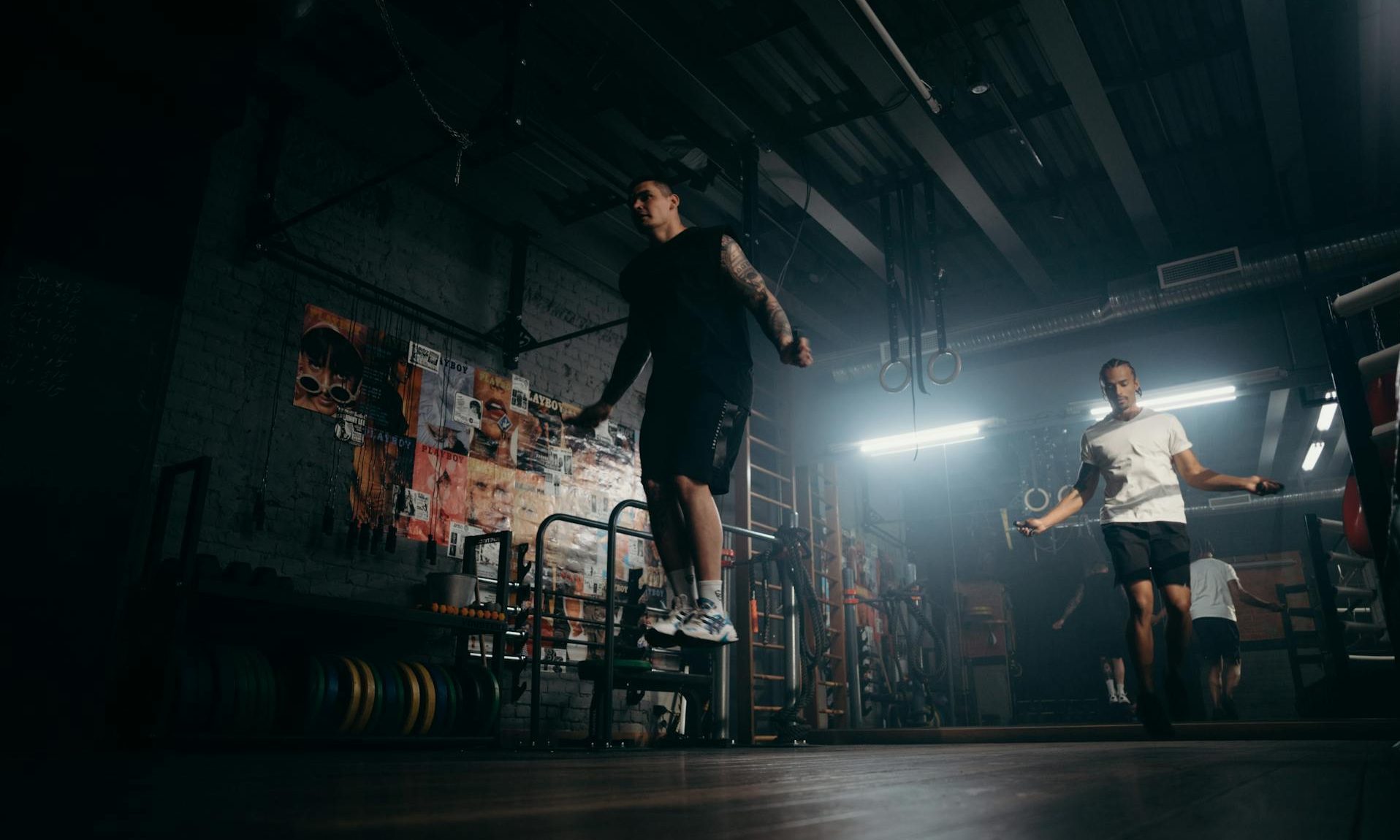 men skipping jumping rope workout HIIT gym