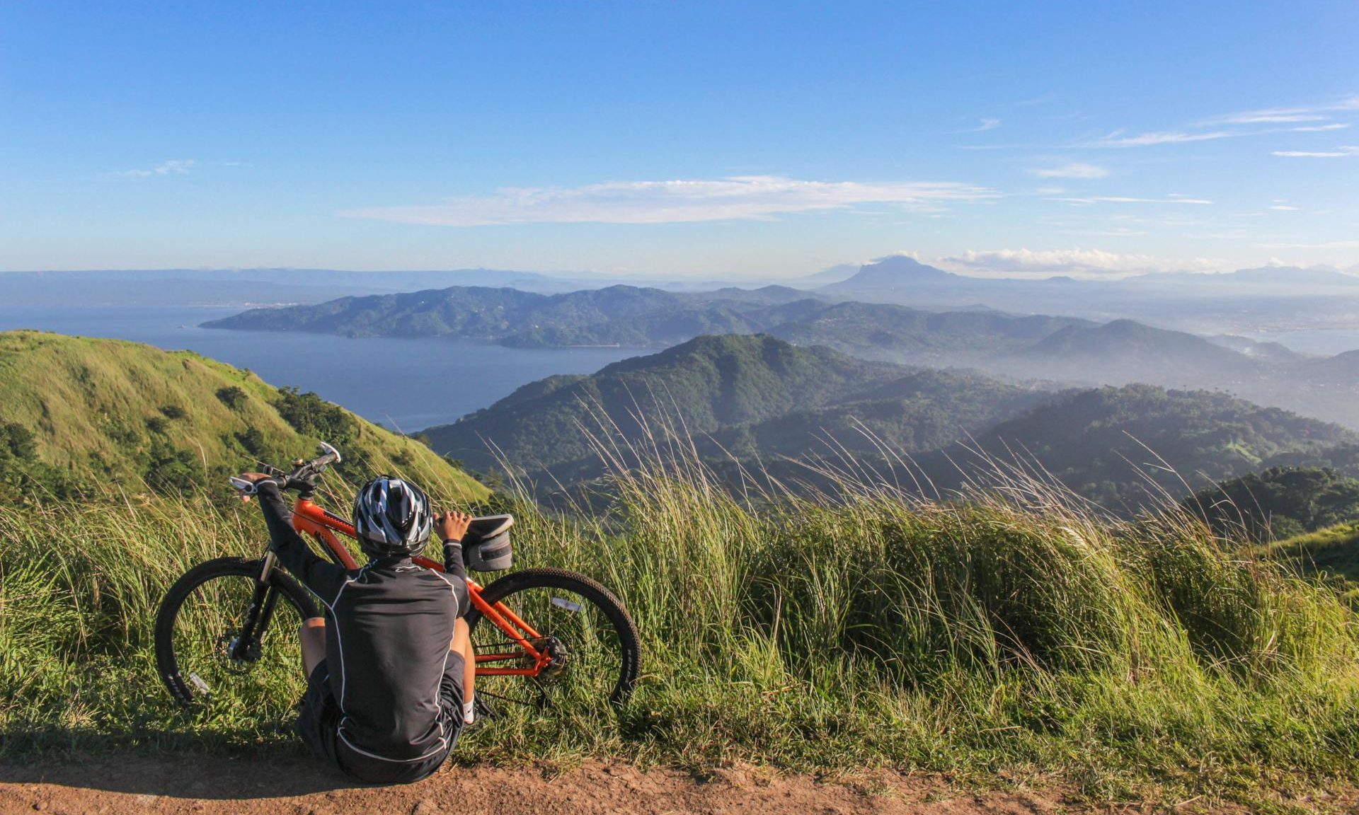 man cycling sitting by mountains