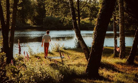 man walking outside by the trees