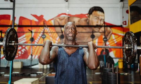 man lifting weights barbell
