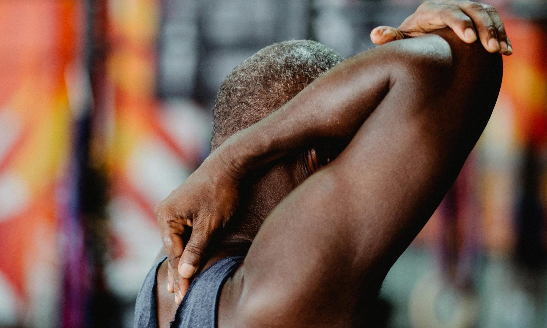 man stretching neck and shoulders