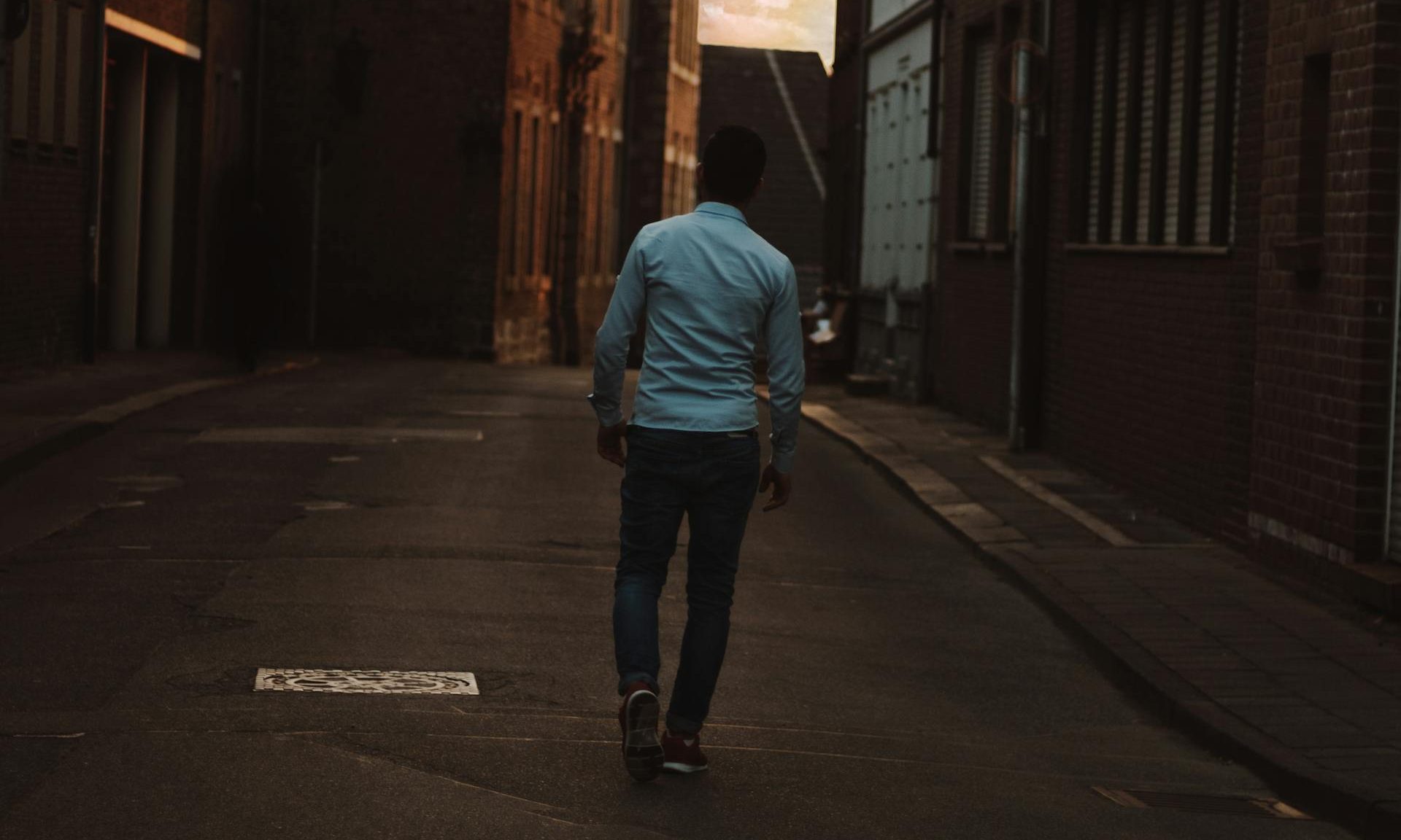 man walking outside birds