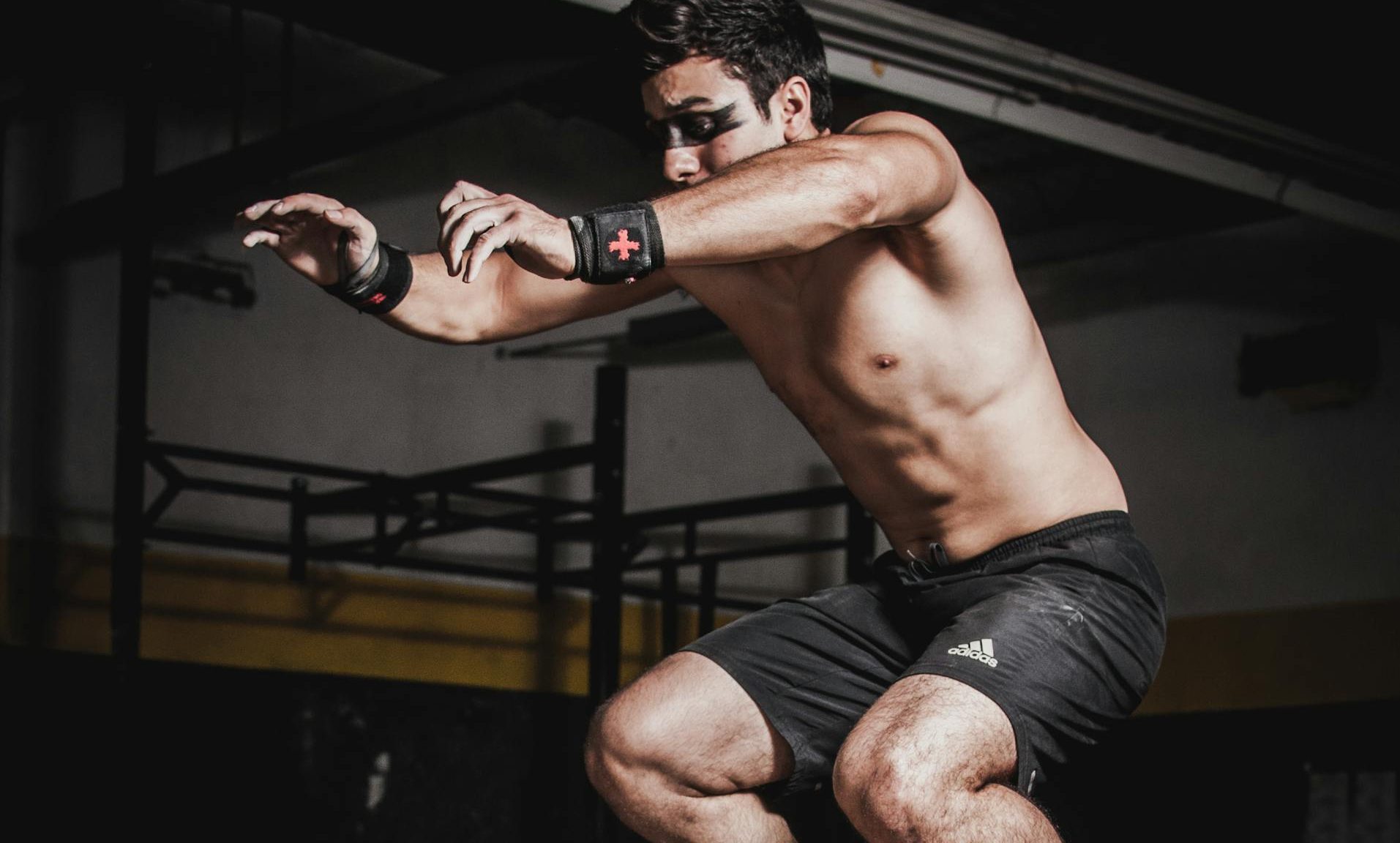 man jumping box jump gym