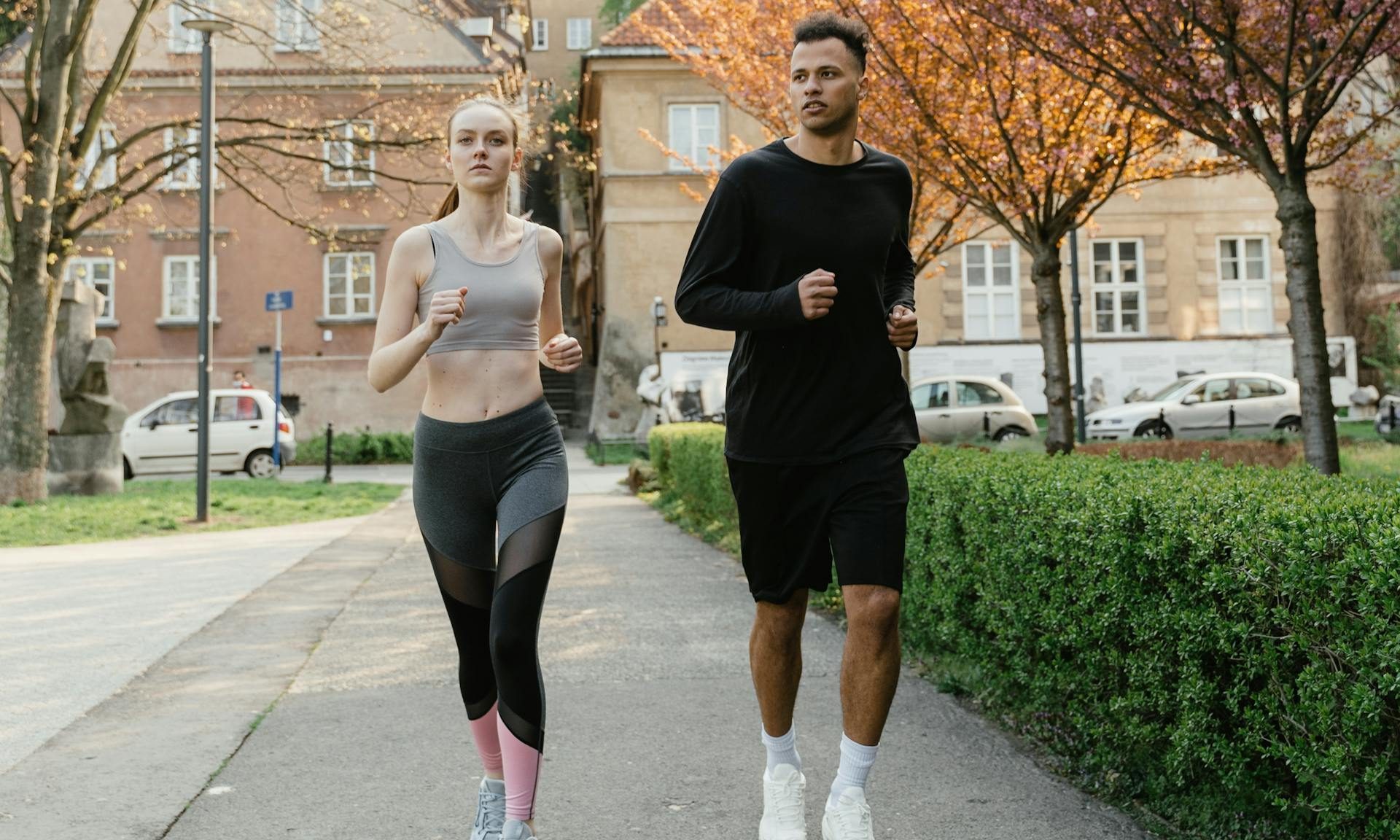 man and woman running outdoors