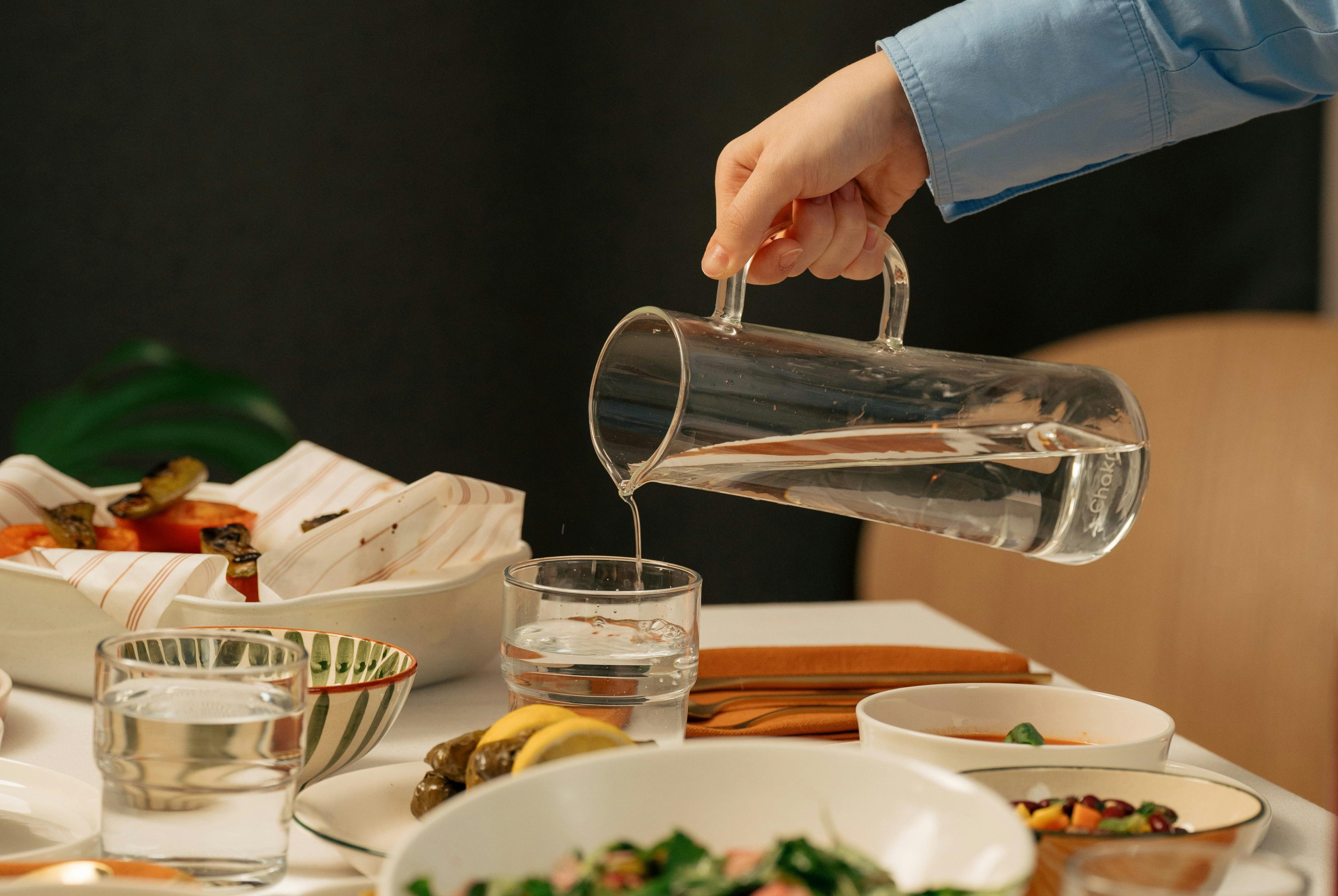 Pouring glass of water.