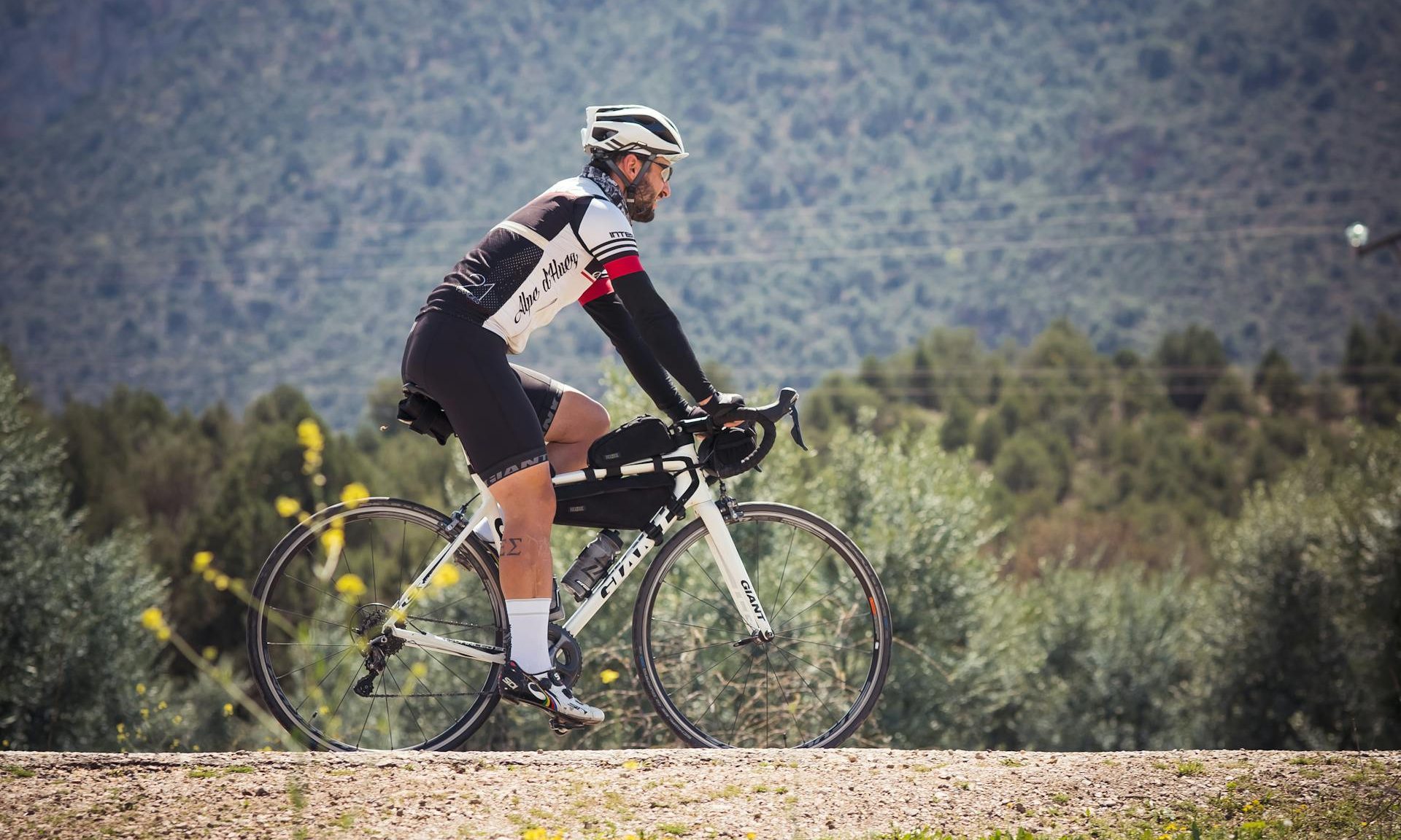 man cycling by the mountains
