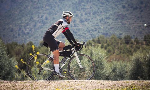 man cycling by the mountains