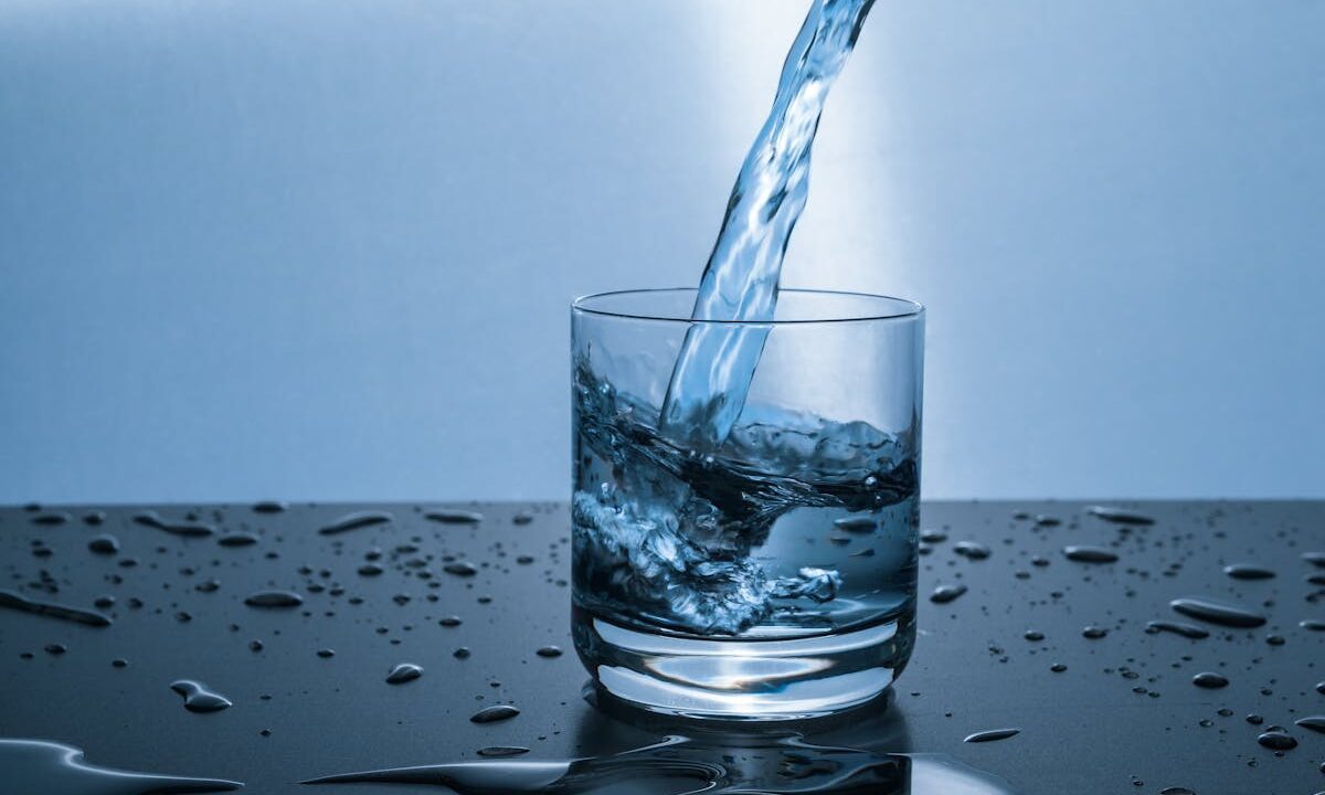 beautiful glass of water on blue background