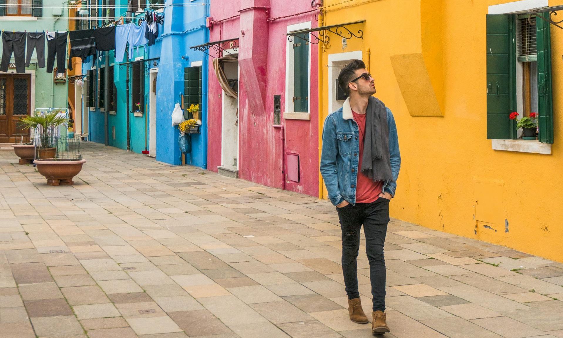 man walking down colorful street