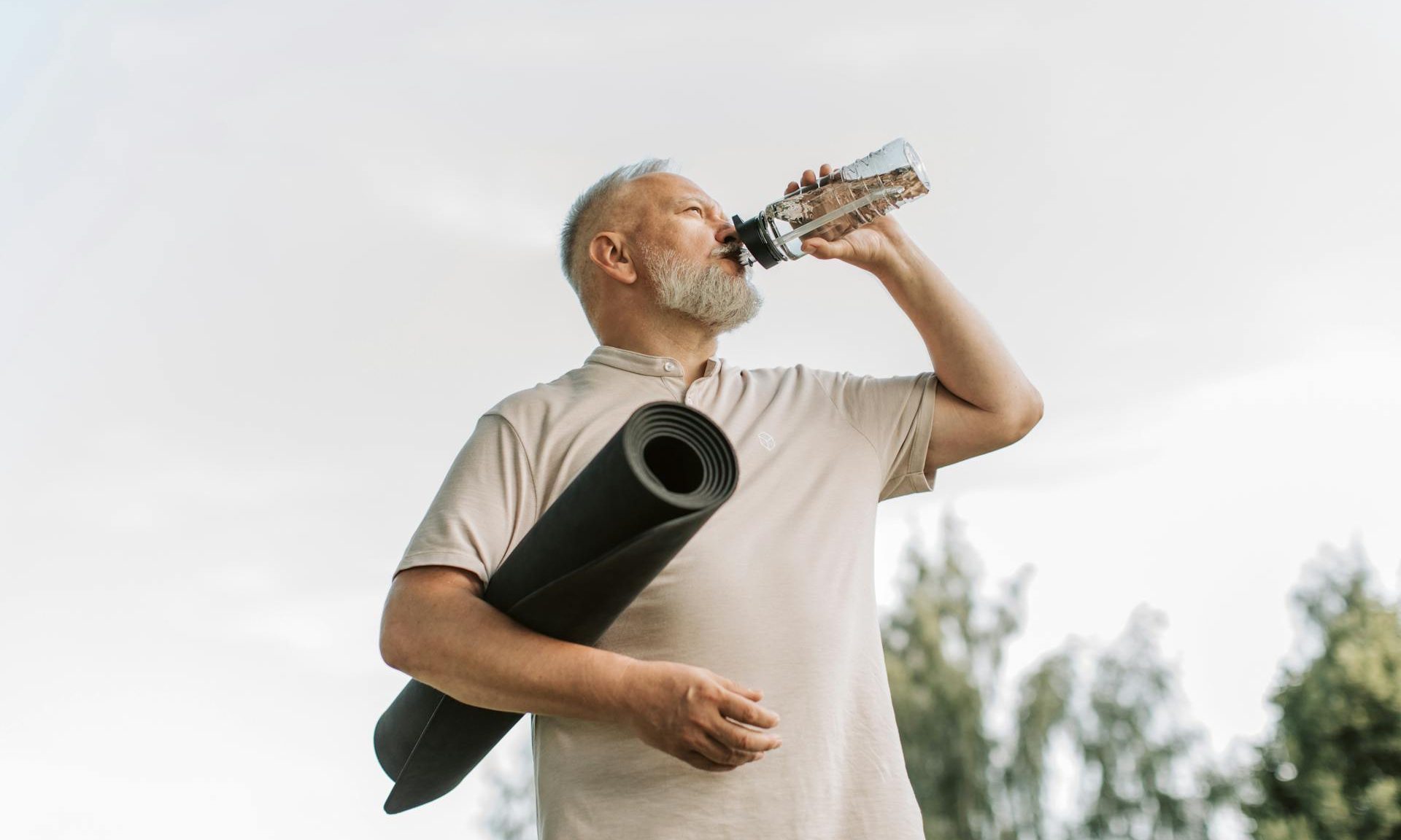 man yoga mat drinking water