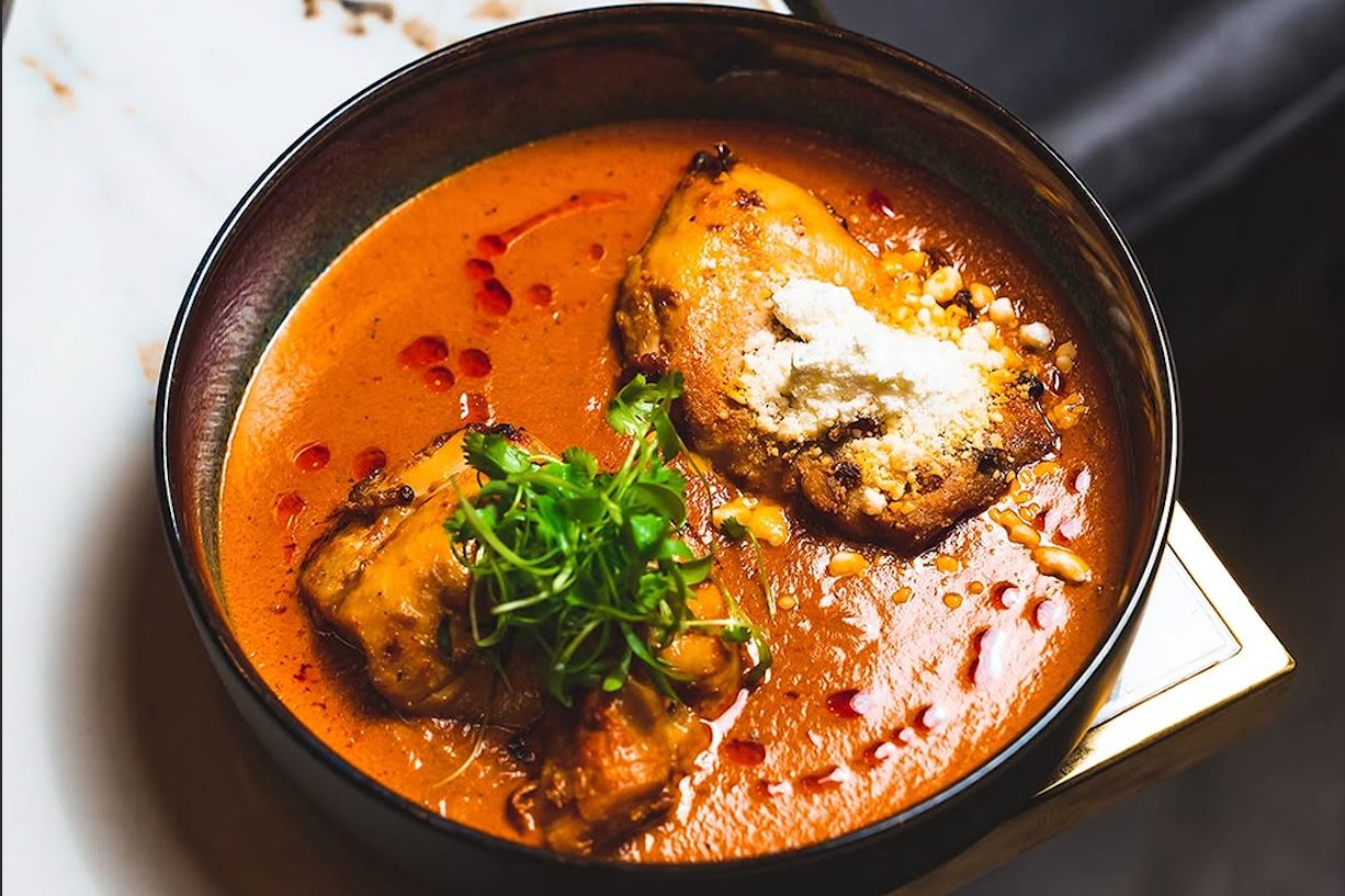 butter chicken in black bowl from tamasha