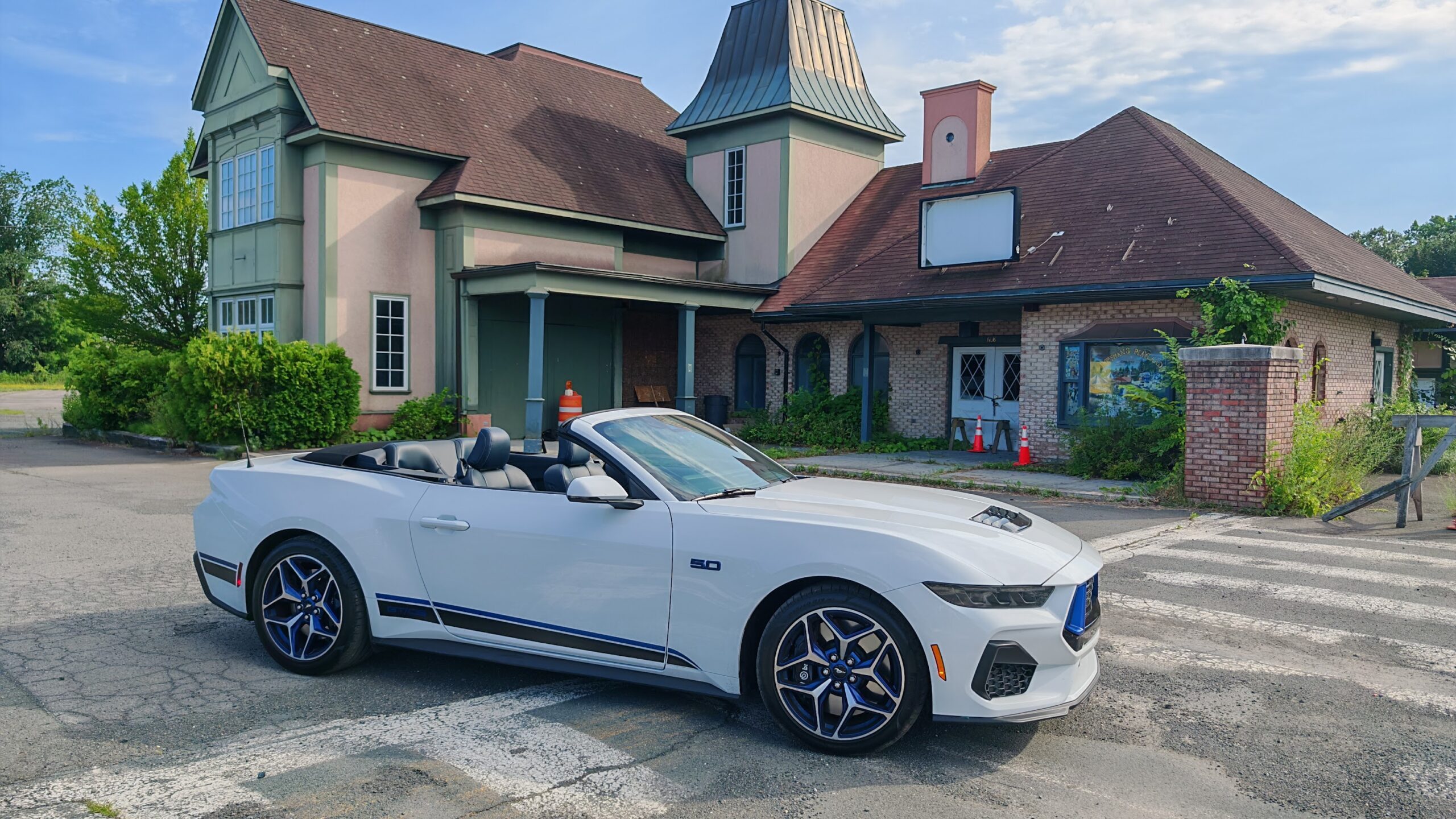 2025 Mustang side view in front of a building