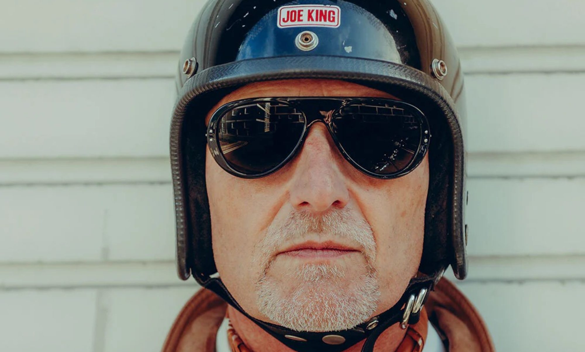 Model wearing Royal Enfield x Vallon Classic 350 Moto Aviators.