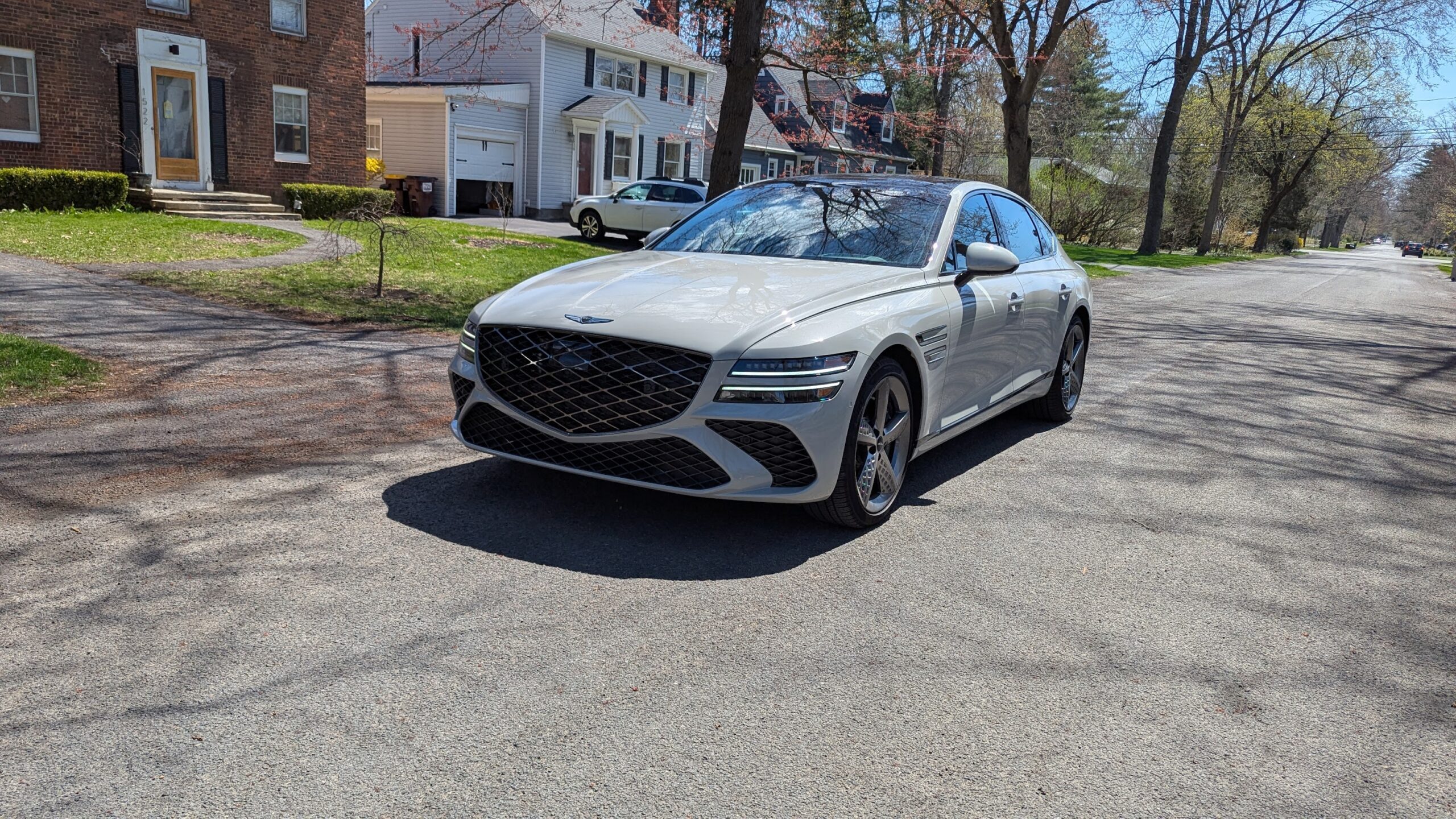 White Genesis G80 in a suburban setting