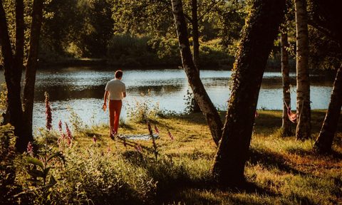 man walking by water