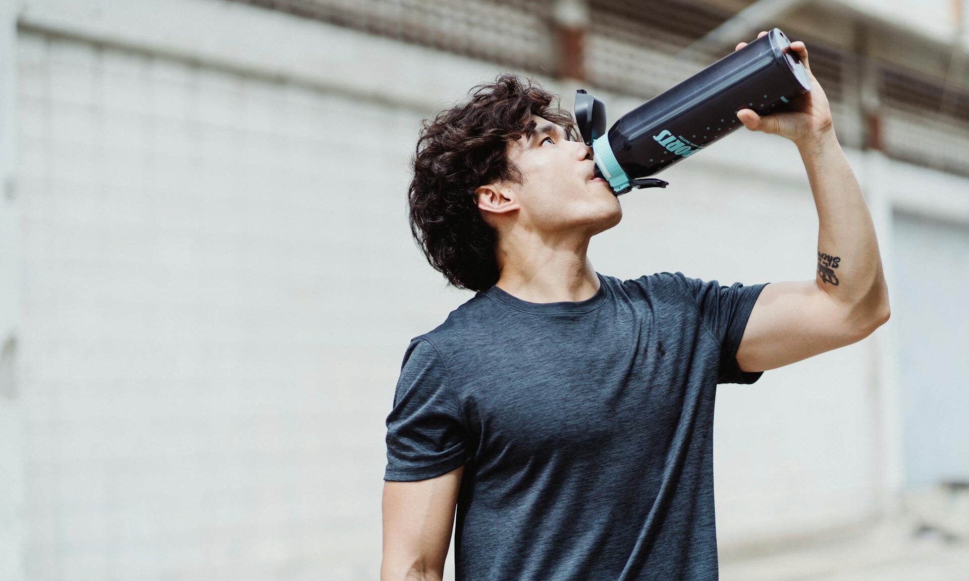 man drinking water sports drink