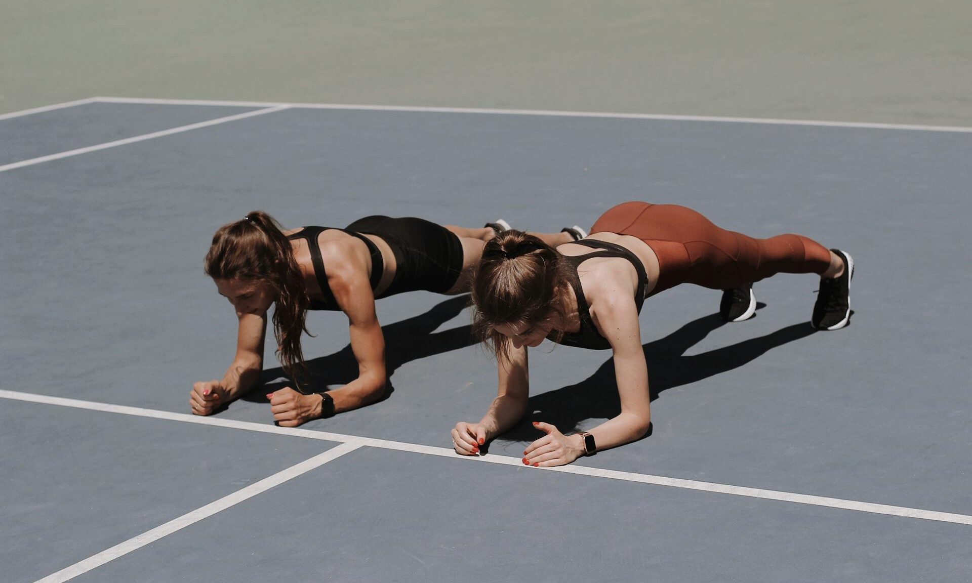 two women doing plank