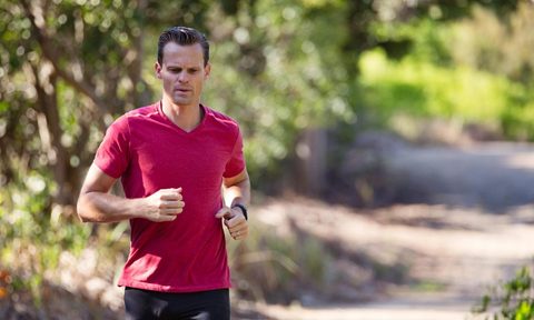 man running on a trail outdoors
