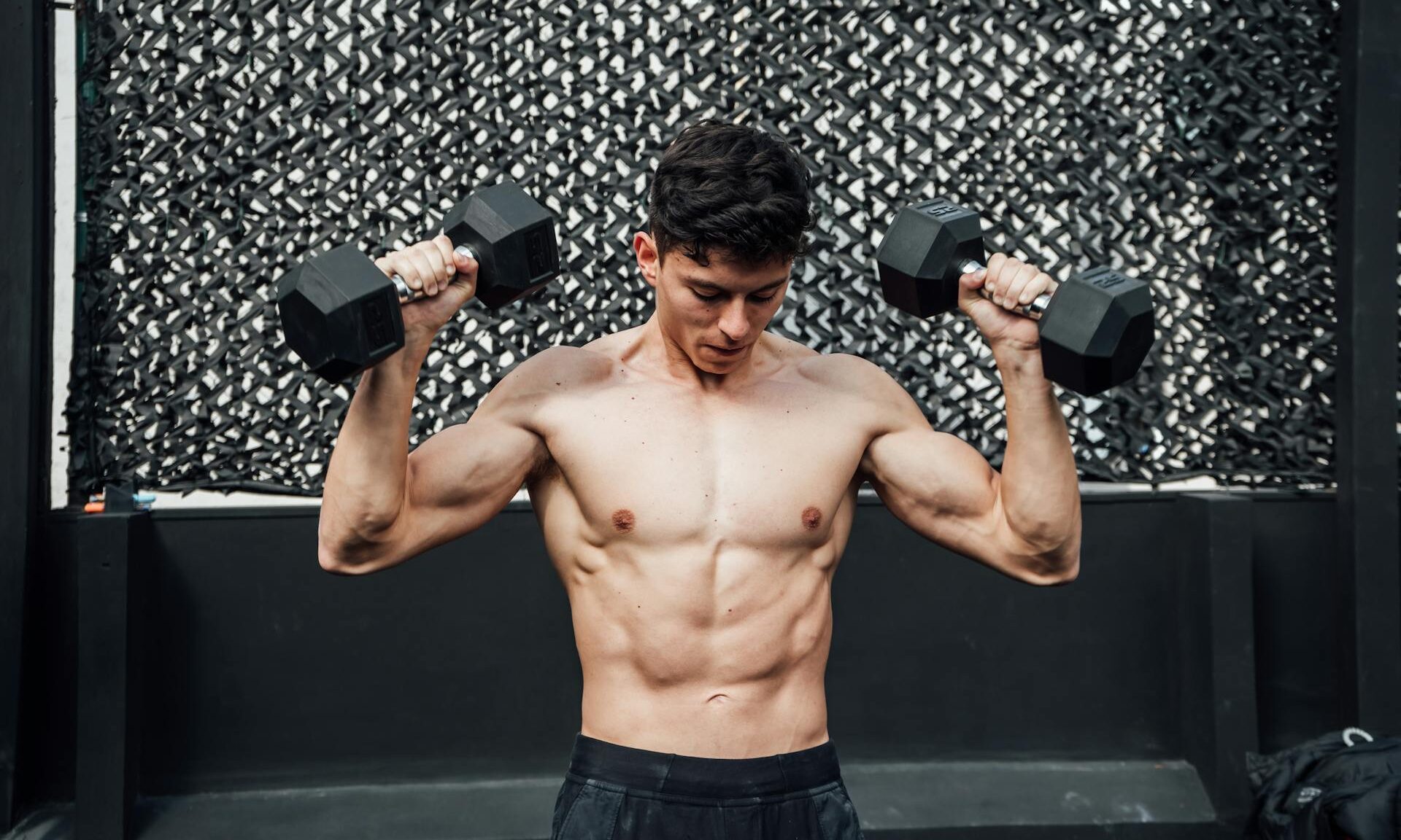 man holding dumbbells lifting weights