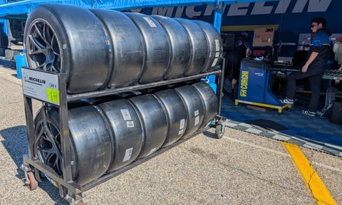Michelin racing tires on a rack stacked up