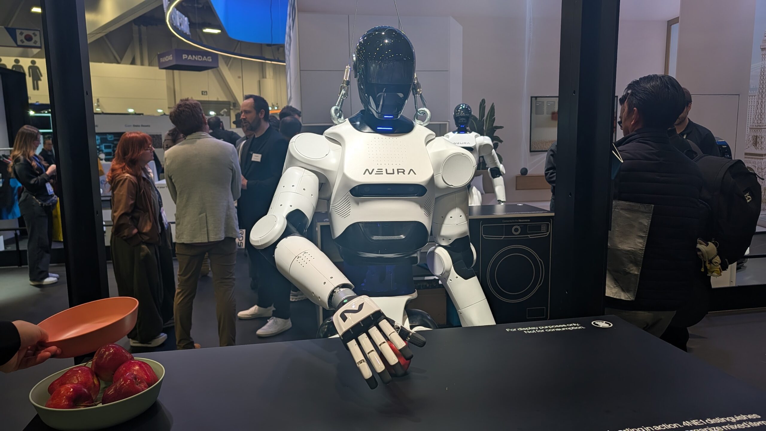 A Neura robot grabbing an apple