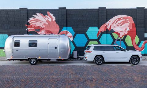 An 2026 Airstream World Traveler 22RB travel trailer parked in front of a large art wall.