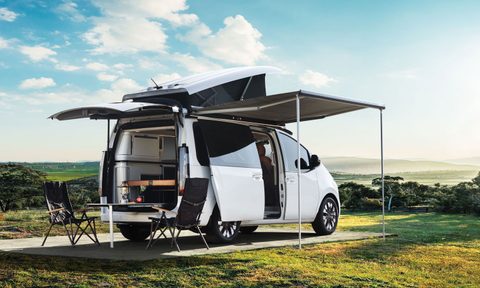 Hyundai Staria electric campervan concept setup in a field.