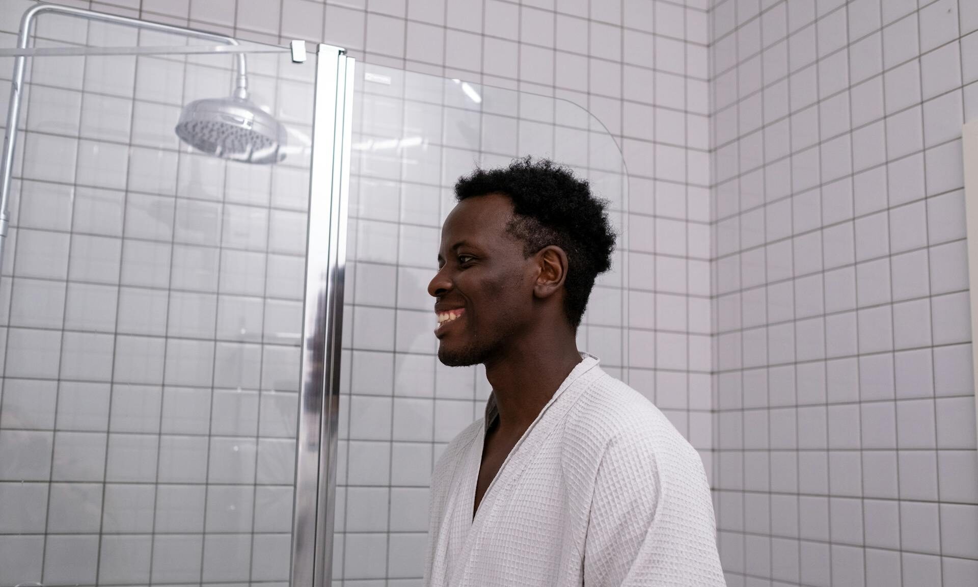 man smiling by shower
