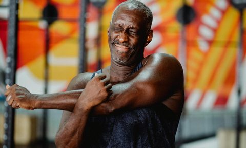 man stretching arm triceps