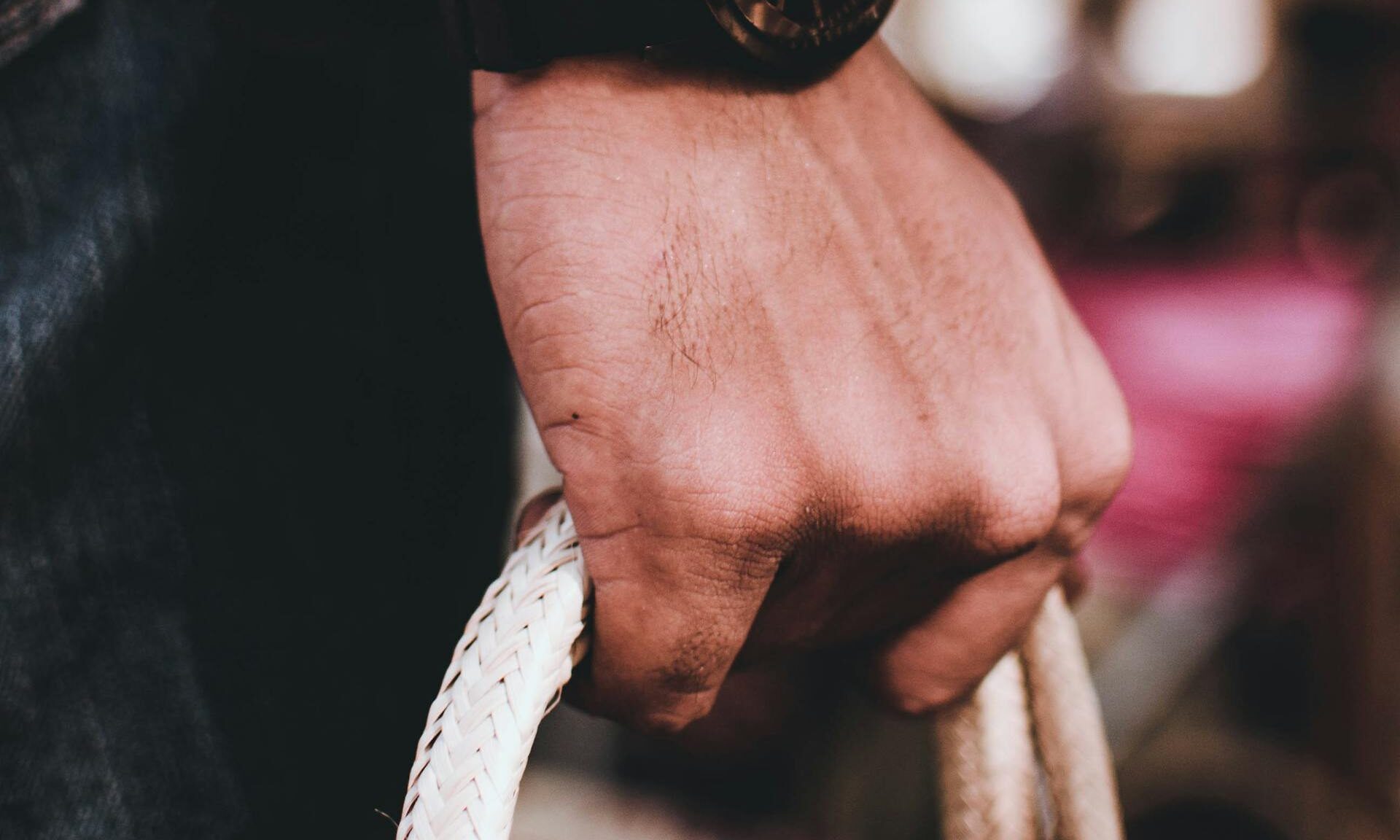 man holding gripping rope
